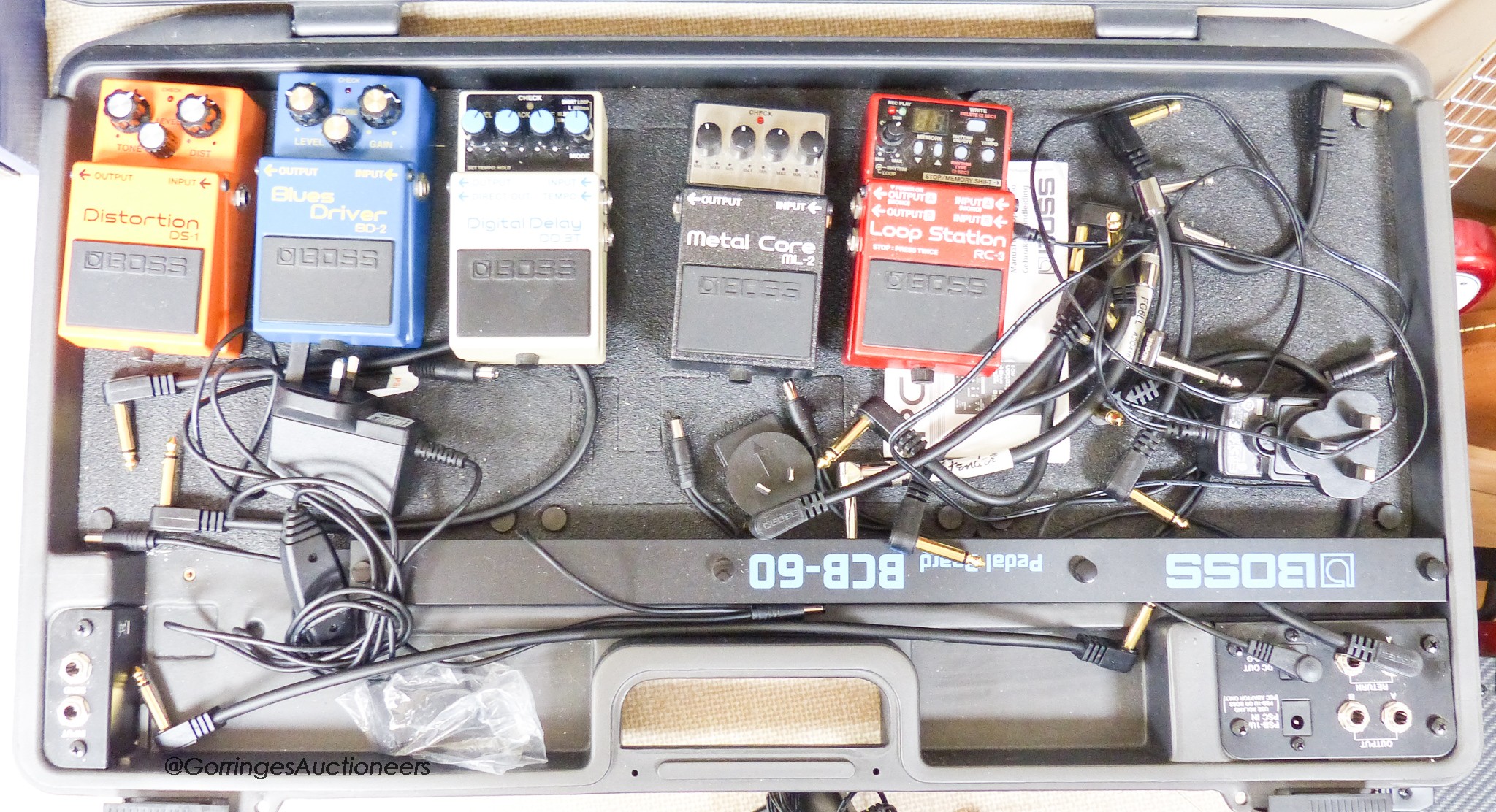 A Boss BCB-60 pedal board, Boss metal core ML-2 pedal, Boss loop station RC-3 pedal, Boss Distortion DS-1 pedal, Boss Blues driver BD-2 pedal, Boss digital delay DD-3T pedal